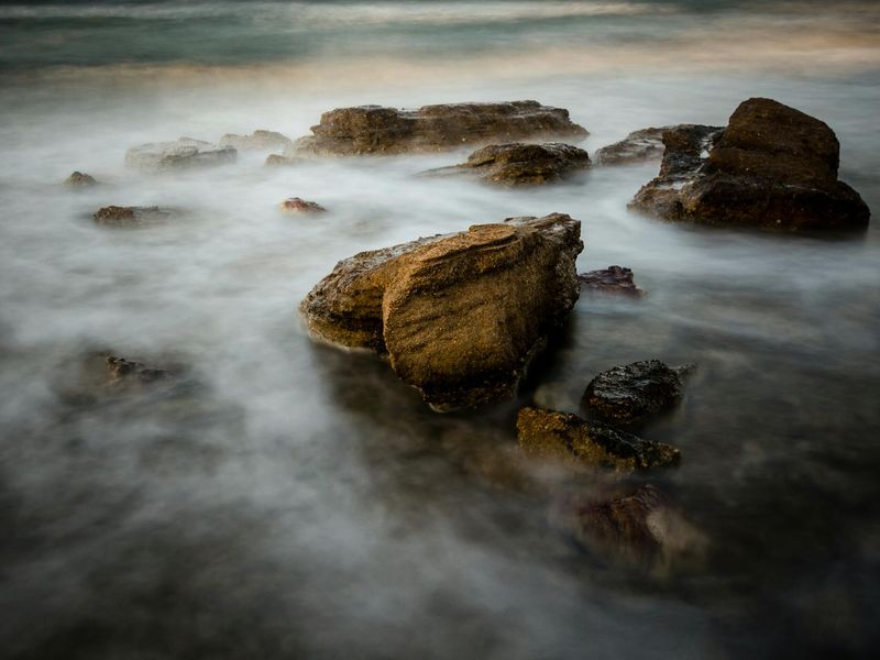 A serene landscape with soft purple tones and a sense of calm.